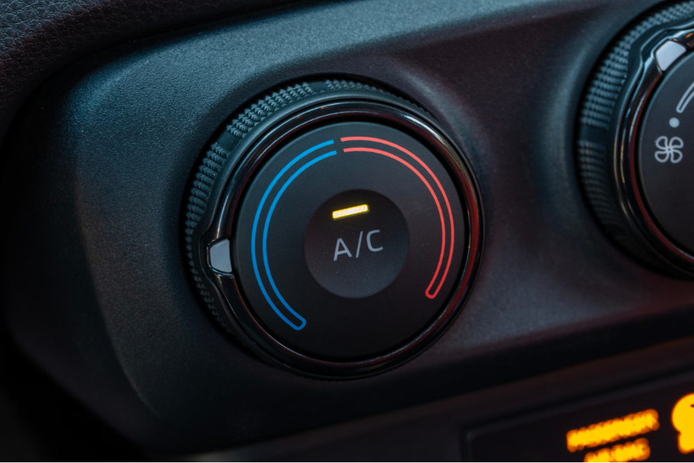 car a/c tips, Auto Repair & Service, Auto Body Repair & Auto Collision Repair in McAllen, Edinburg & Harlingen, TX. Image of an illuminated dashboard A/C temperature dial with cooling and heating indicators for climate control adjustment.