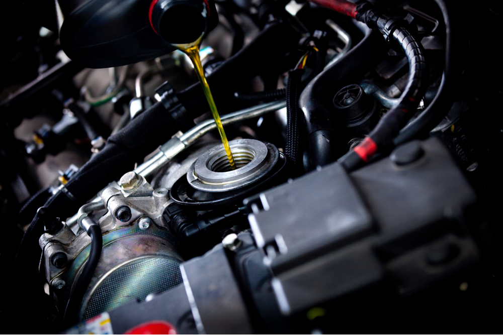 regular oil change, Auto Repair & Service, Auto Body Repair & Auto Collision Repair in McAllen, Edinburg & Harlingen, TX. Image of fresh motor oil being poured into an engine, highlighting preventive maintenance to protect vehicle performance and longevity.