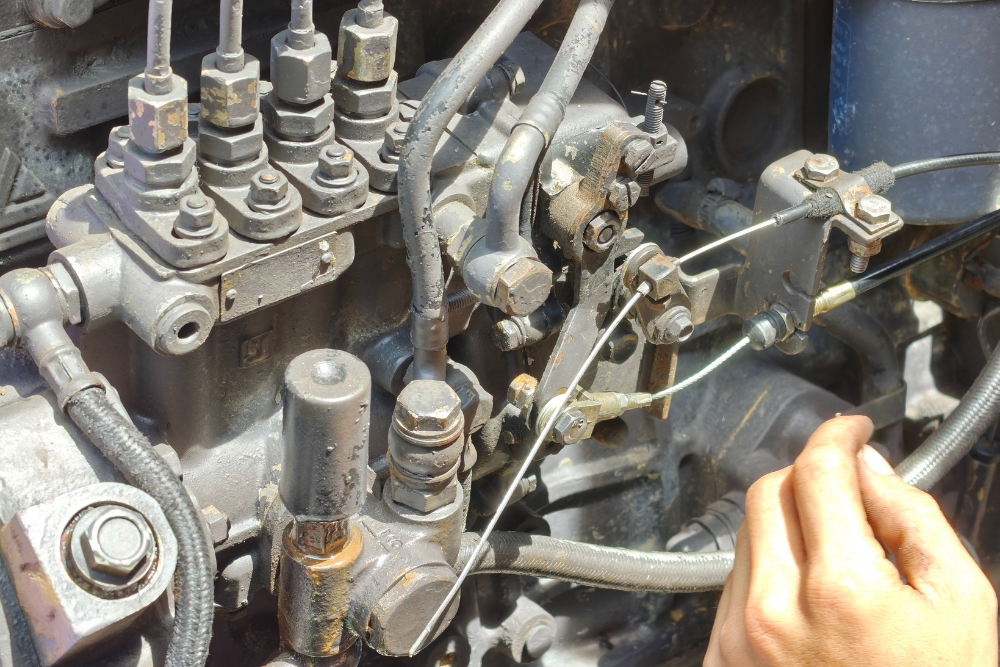 Diesel Engine Repair in McAllen, TX by Premium Automotive. Image of a mechanical inline diesel injection pump with high-pressure steel fuel lines running to individual cylinders, highlighting precise fuel delivery components commonly found on older diesel engines and industrial applications.