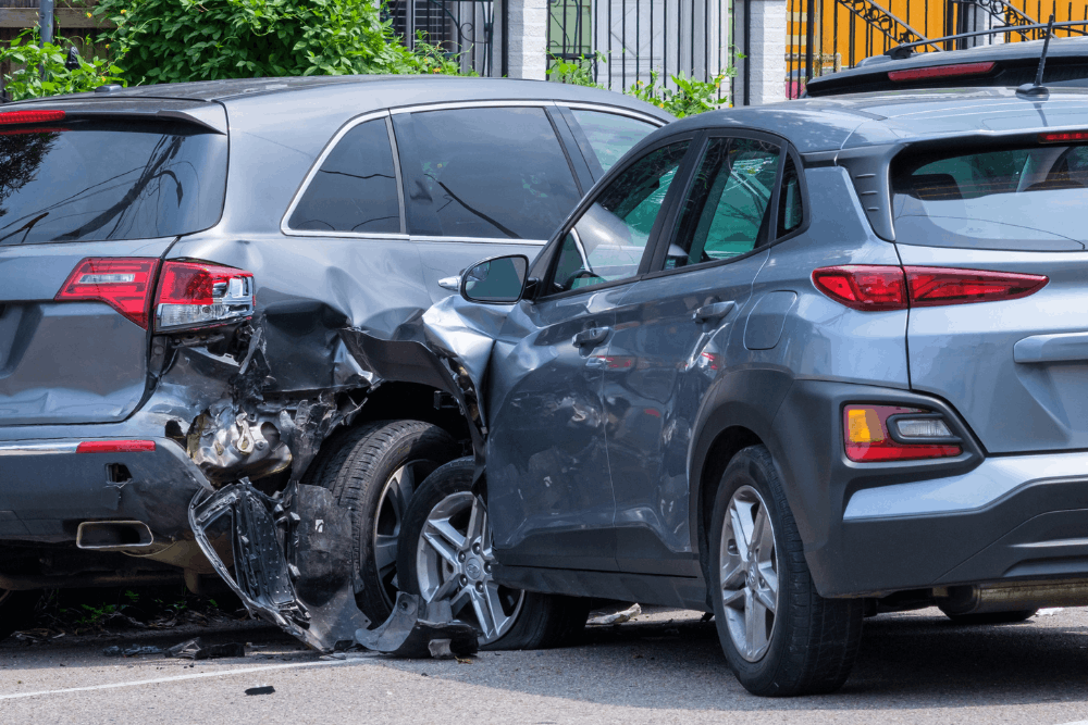 Car accident, collision repair in Harlingen, TX by Premium Collision. Image of two vehicles with rear-end impact damage on a city street. Highlighting structural restoration, precise repairs, and driver safety after an accident.