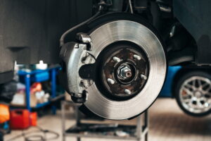 Brake repair in Edinburg, TX, by Premium Automotive. Image of a vehicle’s brake rotor and caliper, highlighting precise diagnostics, reliable stopping power, and safe driving through professional brake maintenance and repair.