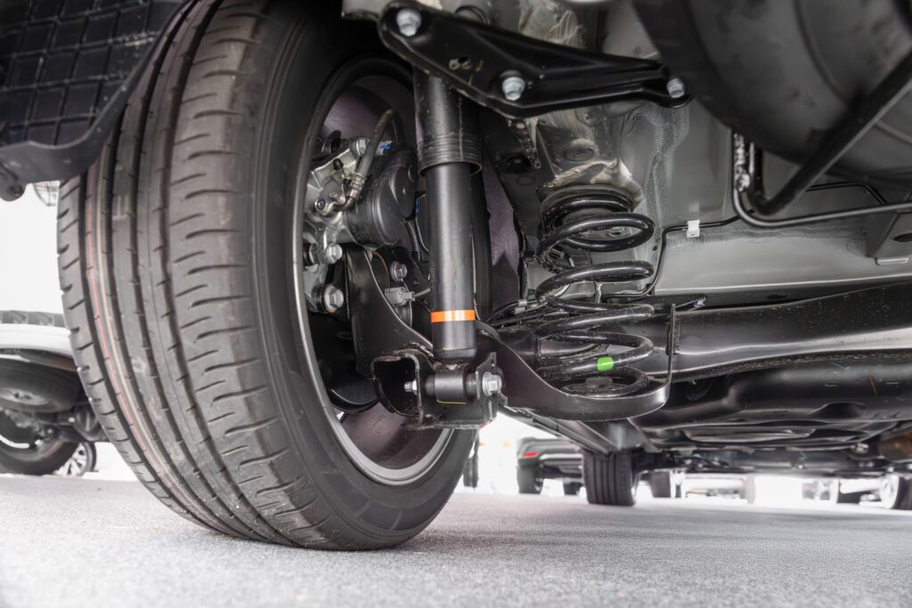 Suspension Repair and Inspection in Edinburg by Premium Automotive, image of an underside of a vehicle, focusing on the tire and alignment