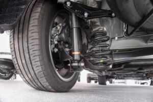 Suspension Repair and Inspection in Edinburg by Premium Automotive, image of an underside of a vehicle, focusing on the tire and alignment