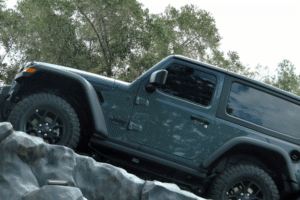 Specialized Collision Repair in Harlingen by Premium Automotive. A jeep going offroad uphill
