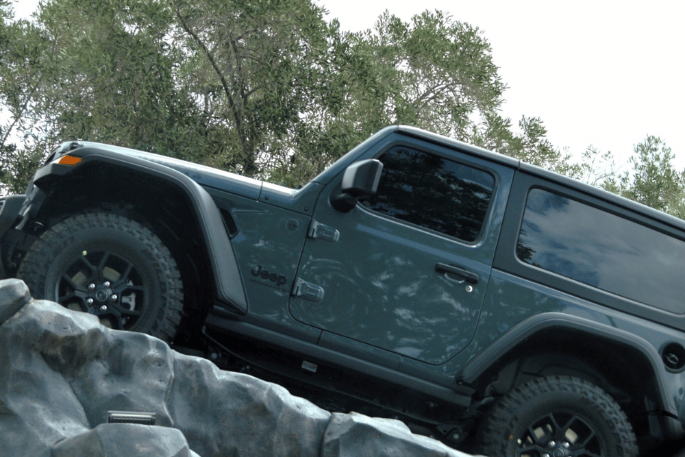Specialized Collision Repair in Harlingen by Premium Automotive. A jeep going offroad uphill