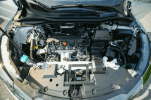 Pre-purchase car inspection in Edinburg, TX showing a technician inspecting a used vehicle engine at Premium Automotive.