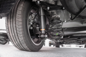 Suspension Repair and Inspection in Edinburg by Premium Automotive, image of an underside of a vehicle, focusing on the tire and alignment