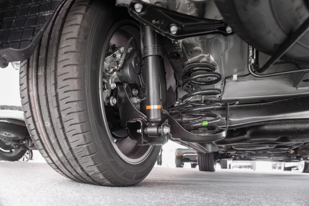 Suspension Repair and Inspection in Edinburg by Premium Automotive, image of an underside of a vehicle, focusing on the tire and alignment