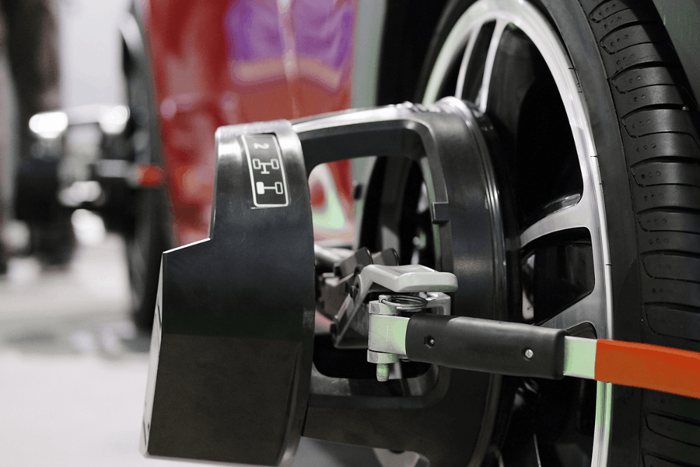 Wheel alignment, auto repair in McAllen, TX, at Premium Automotive. Image shows a vehicle wheel fitted with alignment sensors to improve steering, handling, tire life, and overall driving safety through accurate suspension alignment.