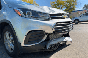 Collision repair in Harlingen, TX, at Premium Collision. Image shows impact damage to the hood, bumper, grille, and front fascia, highlighting the need for expert structural repair, parts replacement, and paint restoration.