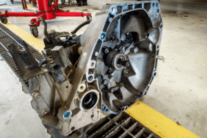 Transmission repair vs. replacement, auto repair in McAllen, TX. Image of a removed transmission housing with the input shaft and internal components visible during inspection and automotive service.